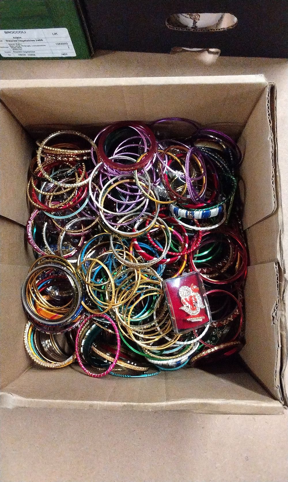 Lot 239: A Collection of Multi-Colored Bangles and Ganesha Figurine