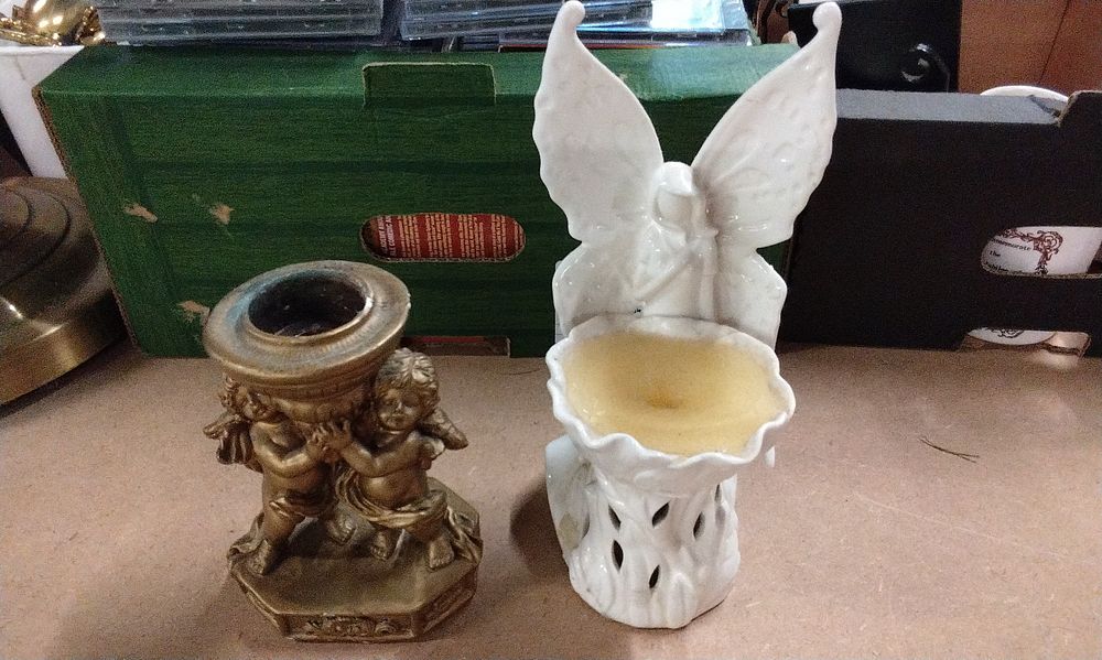 Lot 245: A Bronze Cherub Candlestick and Ceramic Butterfly Wax Warmer