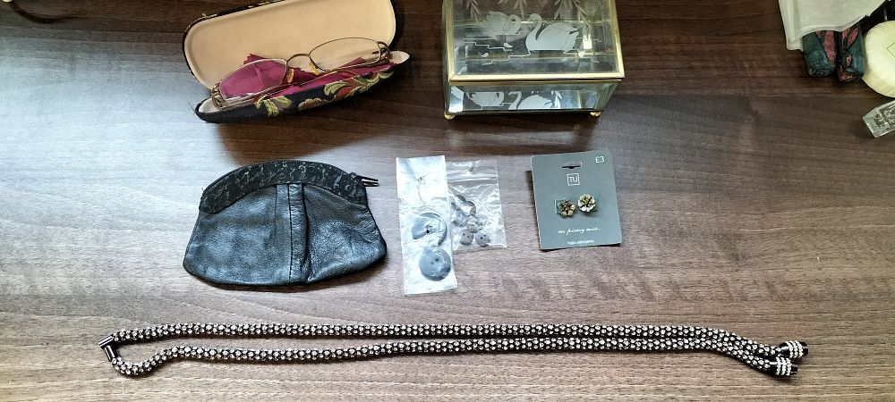 Lot 253: A Collection of 7 Assorted Accessories and Jewelry including Joan Collins Branded Glasses and a set f Earrings.