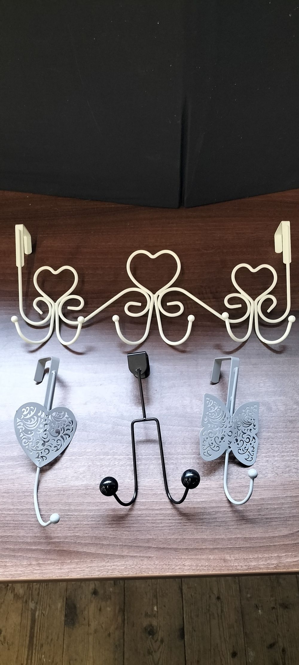 Lot 254: A Set of 4 Decorative Over-Door Metal Hooks
