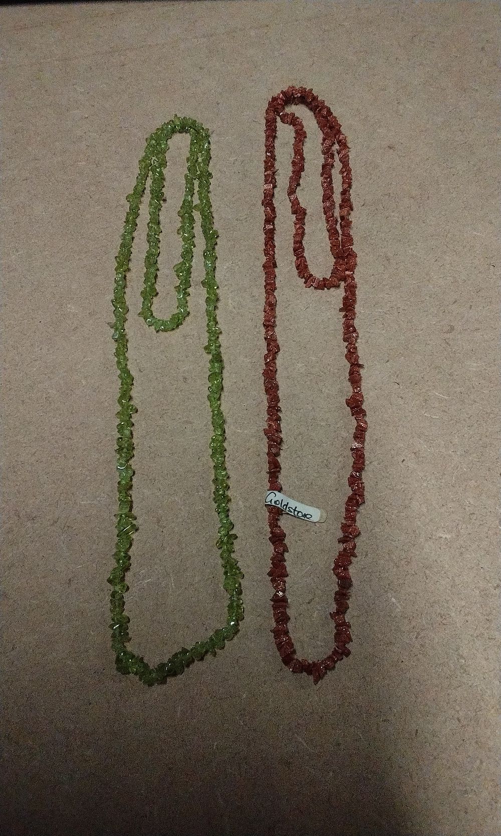 Lot 296: A Pair of Goldstone and Peridot Gemstone Chip Bead Strands