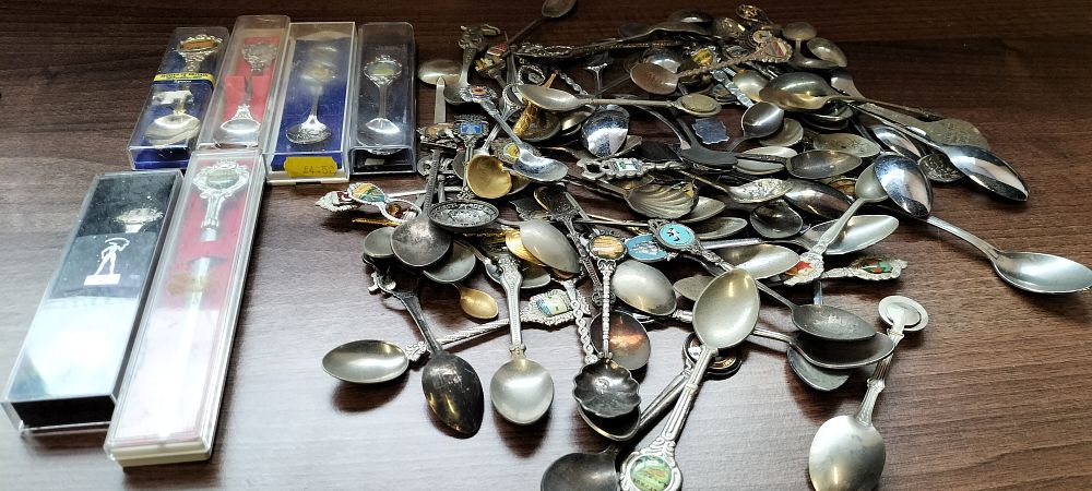Lot 310: A Large Quantity of Souvenir Tea Spoons & Five Wooden Souvenir Spoon Display Shelves