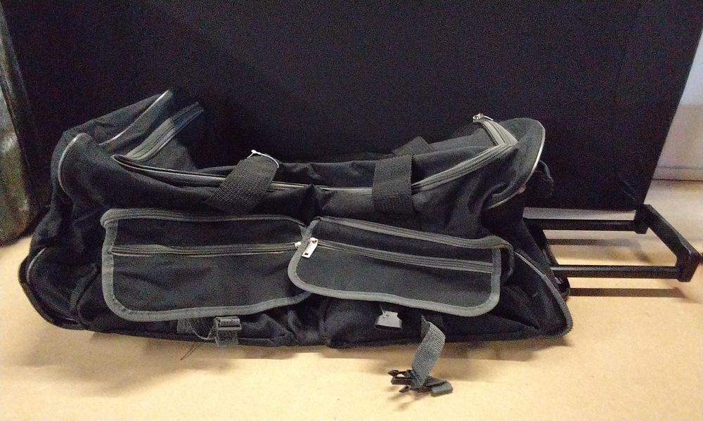 Lot 376: A Modern Black Rolling Duffel Bag