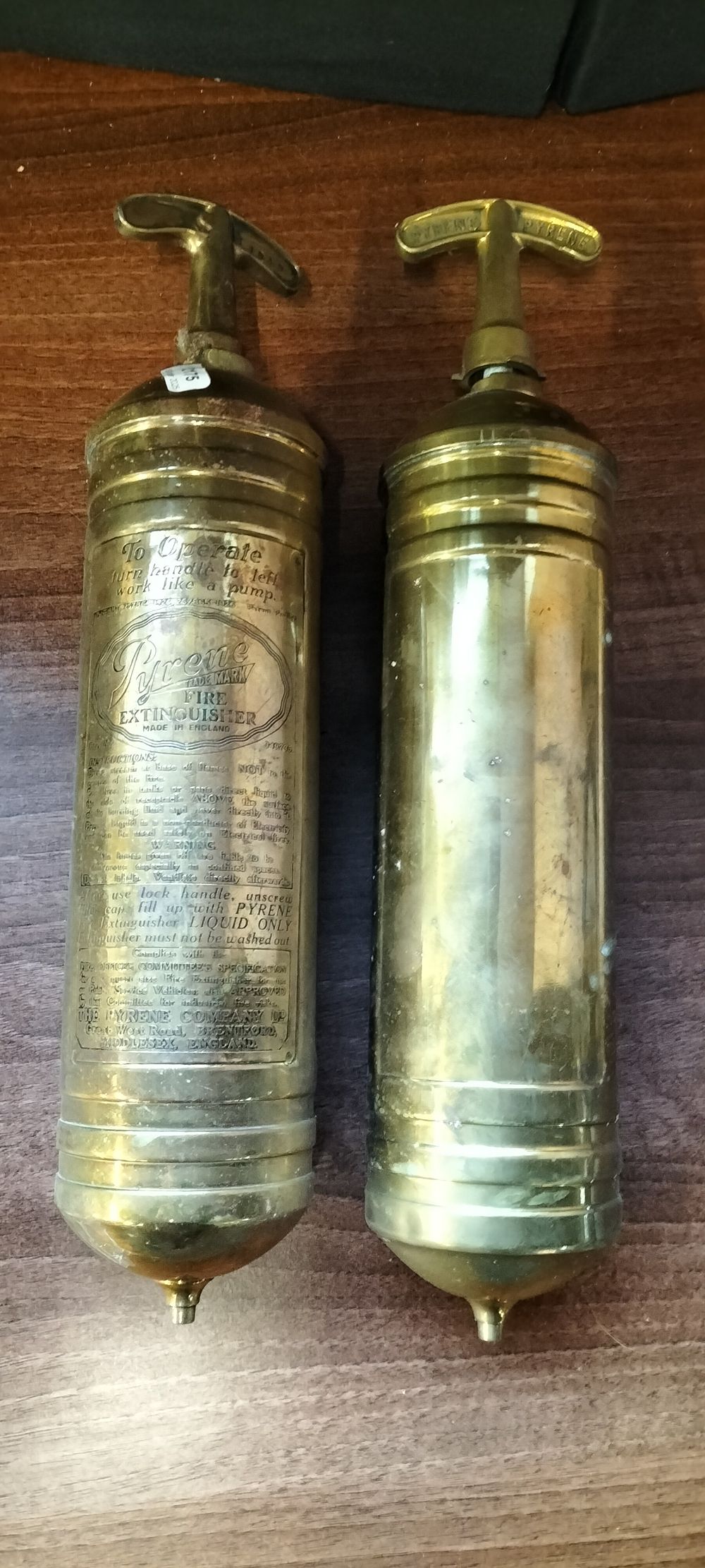 Lot 467: A Pair of Pyrene Brass Fire Extinguishers, 1939