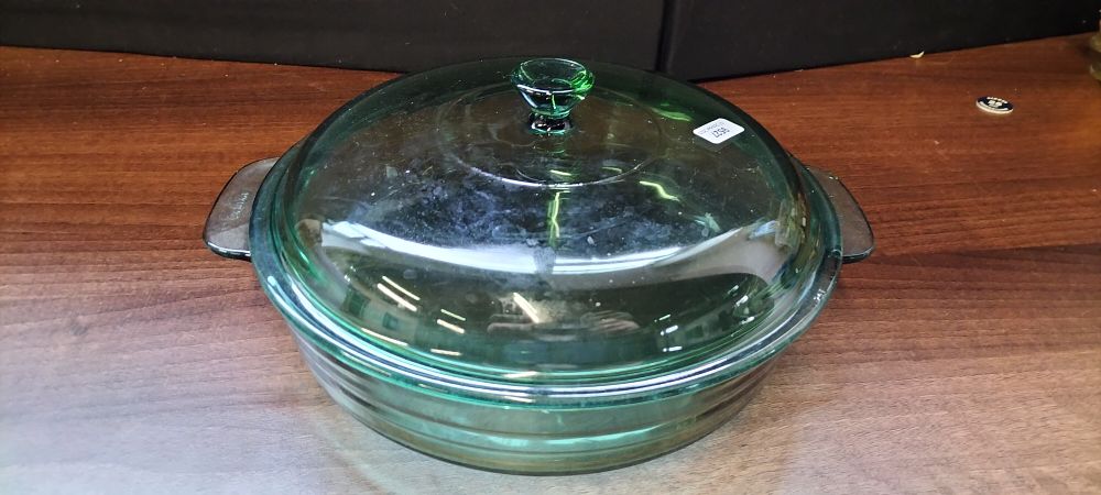 Lot 482: A Pyrex Dark Green Glass Casserole Dish with Lid, Made in France