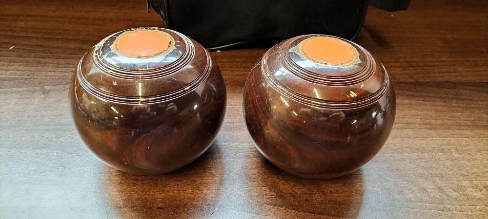 Lot 767: A Pair of English Lignum Vitae Lawn Bowls