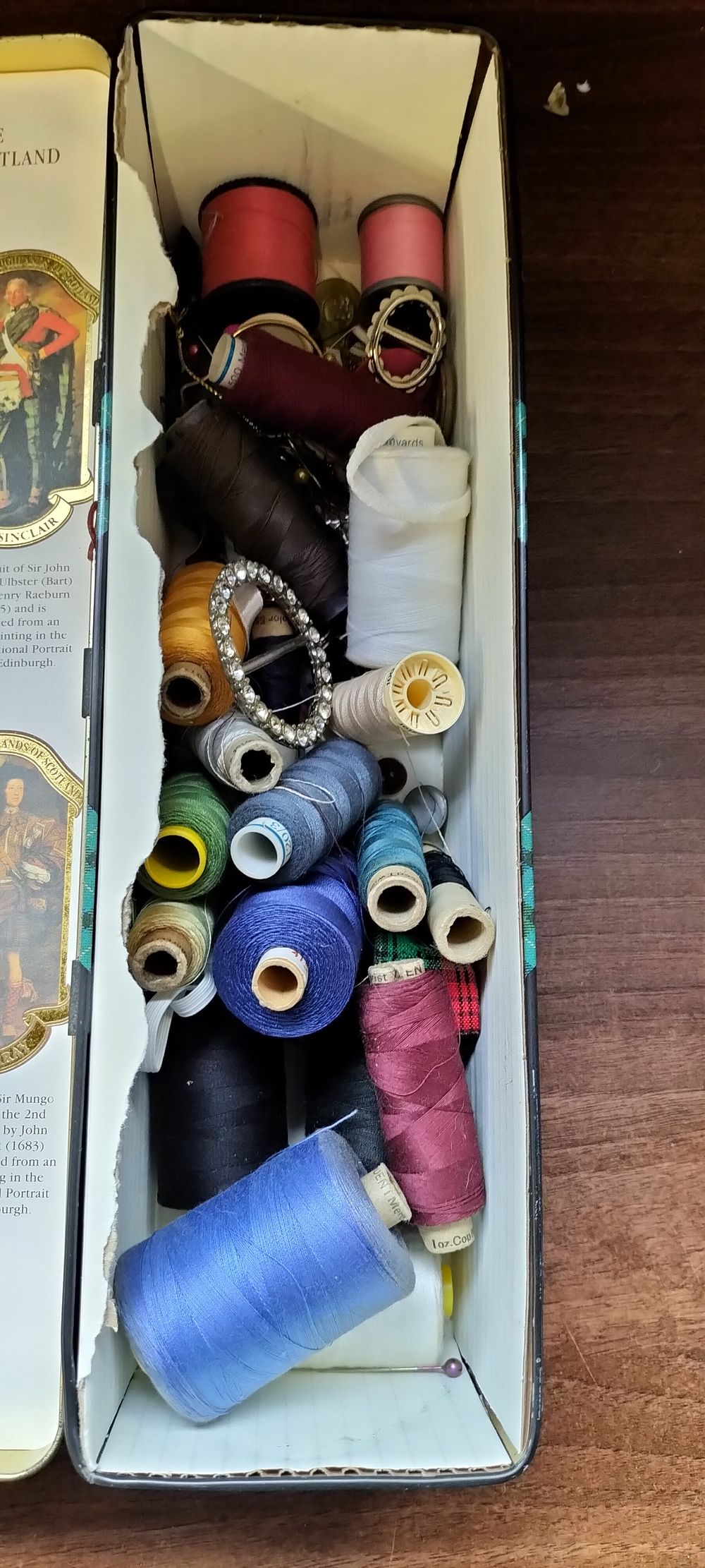 Lot 787: A Collection of Sewing Thread, Notions, and Accessories in Glenfiddich Tin