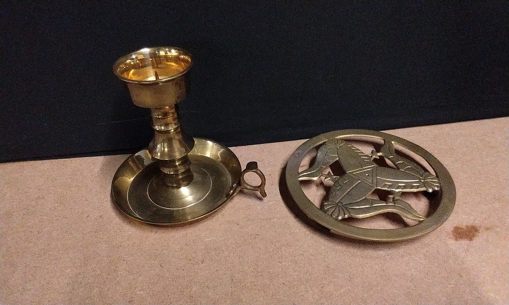 Lot 682: A Brass Chamberstick and Decorative Triskelion Piece