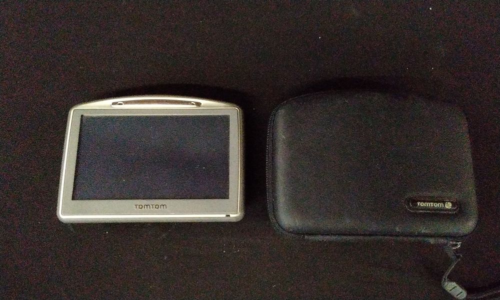 Lot 704: A TomTom One GPS Device and Protective Case. No Power Supply