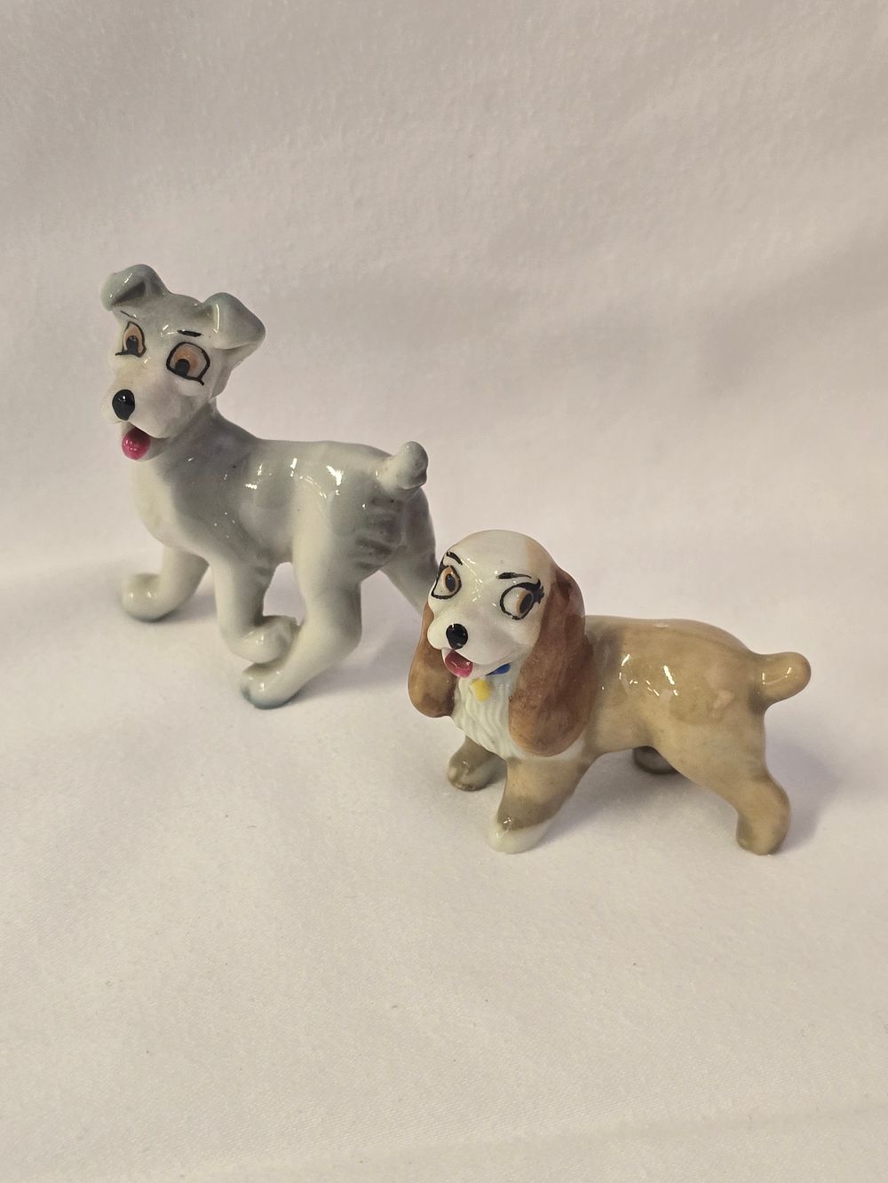 Lot 305:  a set of vintage Wade Whimsies figurines of the Disney characters Lady and the Tramp.