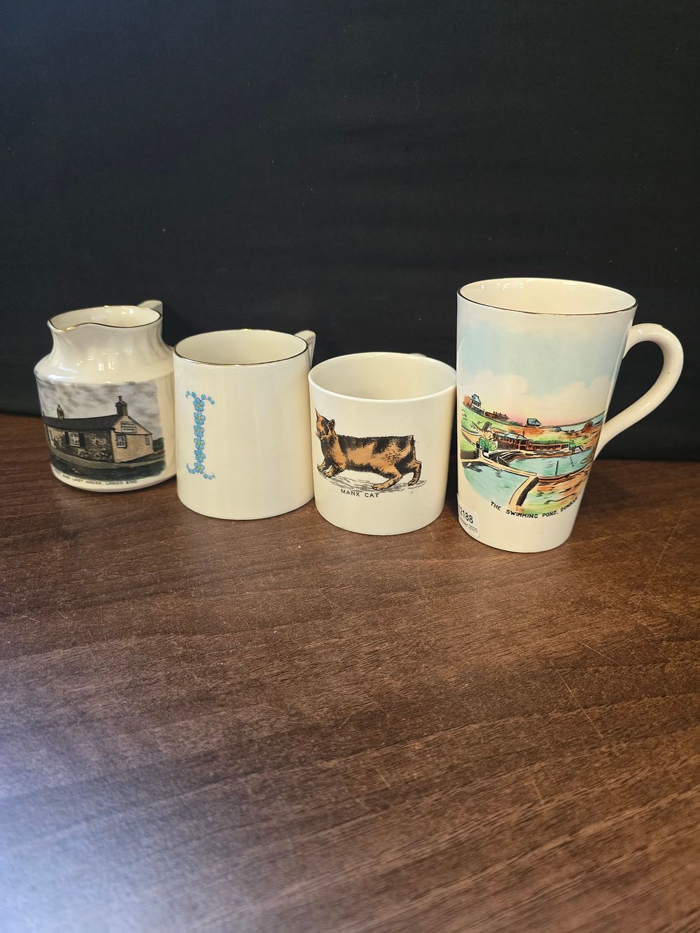 Lot 307: Four vintage pieces of W.H.Goss.  cups, and jug depicting various scenes from various locations