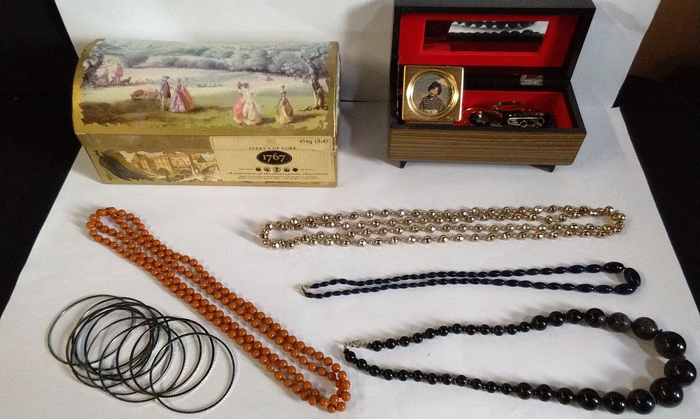 Lot 727: Terry's of York Chocolate Box Containing Various Costume Jewellery Necklaces and Bracelets, and a Musical Jewellery Box
