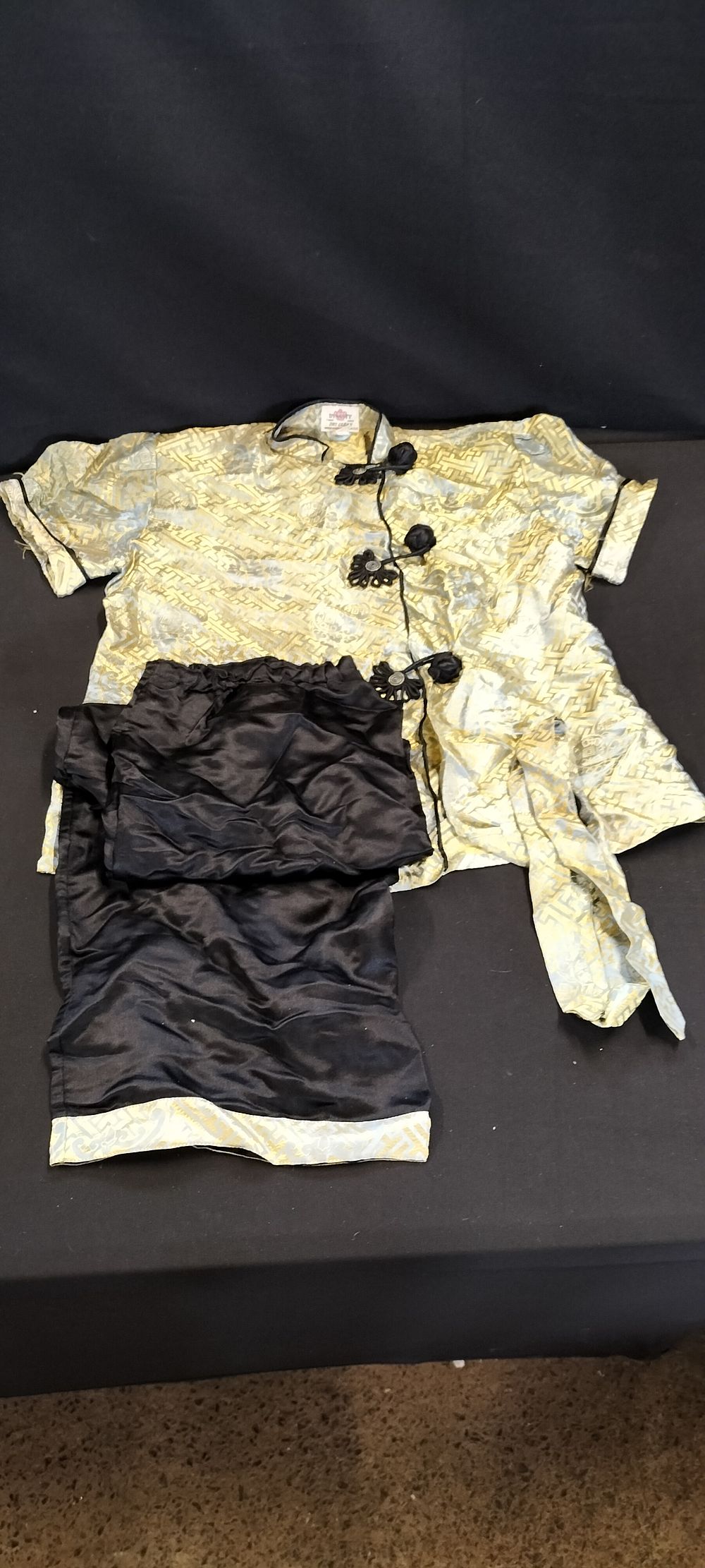 Lot 186: A Vintage Gold and Black Traditional Silk Tang Suit Set, with Trousers and a Belt