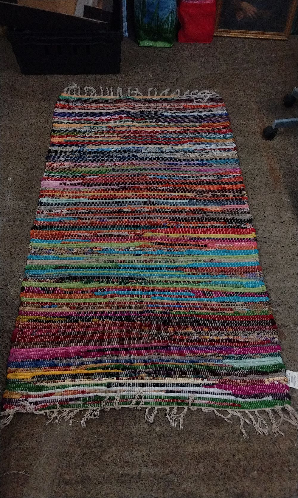 Lot 299: Multi Coloured Woven Material Fringed Rug