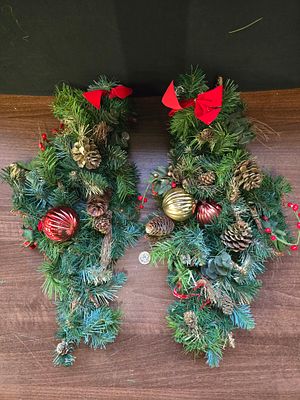 A pair of drop style Christmas wreaths