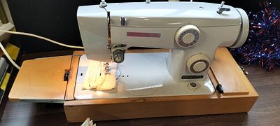 A Necchi Sewing Machine. A Necchi35 Sewing Machine, Electric Pedal, Wooden Storage/Carry Box 