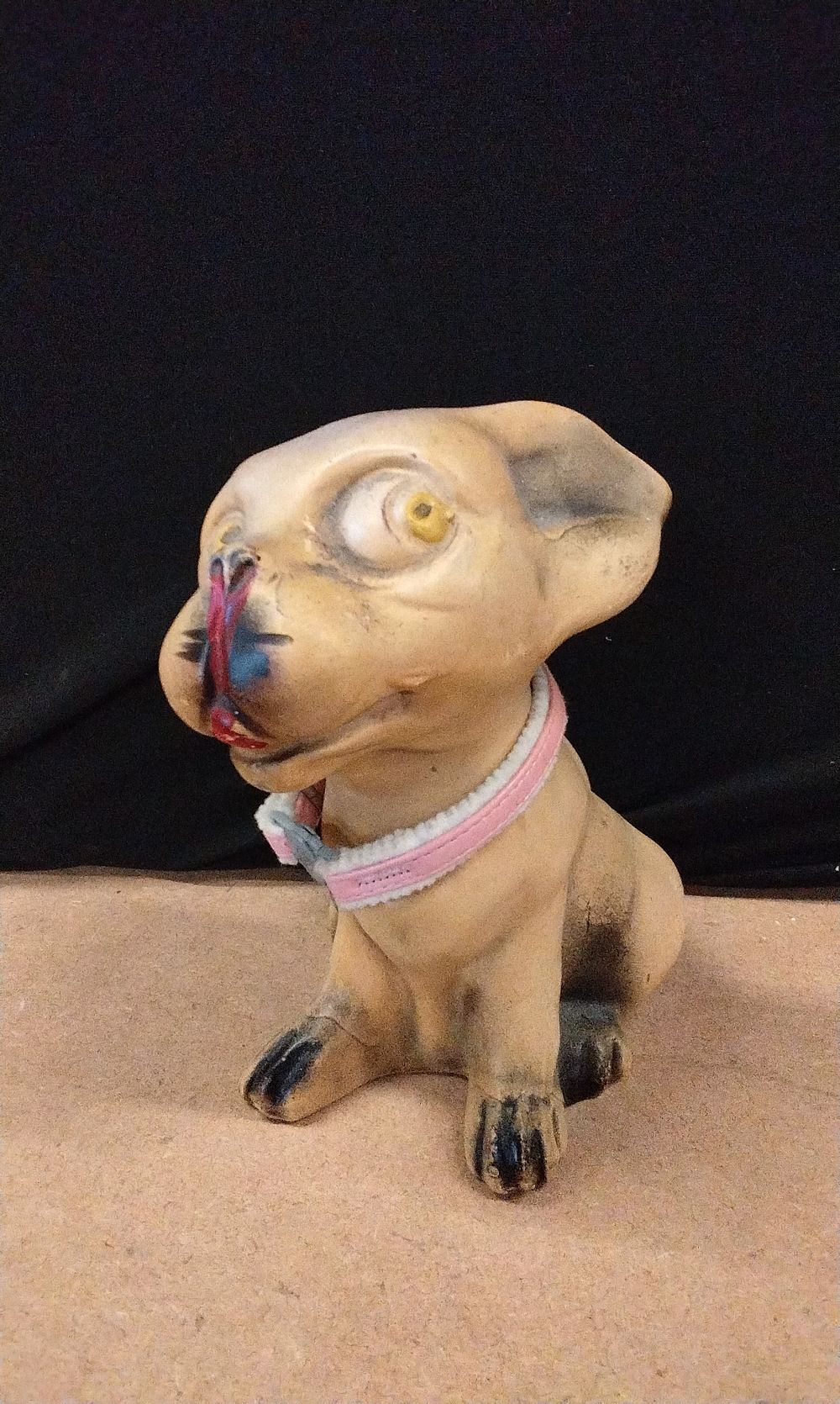 Lot 193: Tan, Black, Red, and Yellow Dog Figurine
