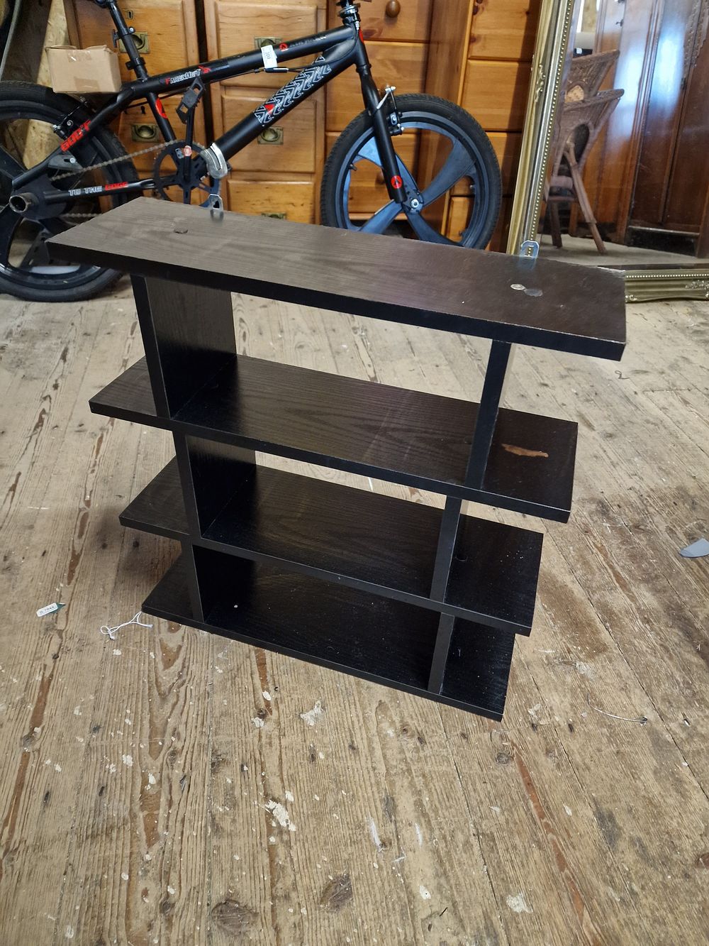 Lot 329: A Black Multi-Tiered Four-Shelf Unit
