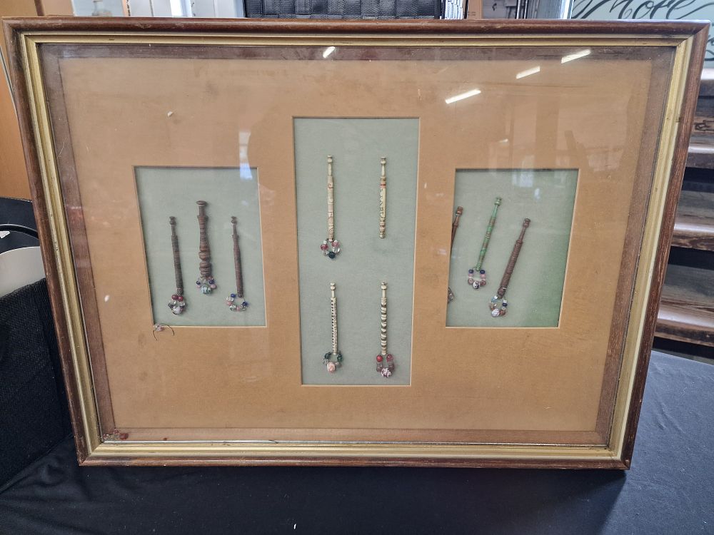 Lot 331: A Framed Display of 10 Antique Lace Bobbins