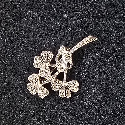 Sterling Silver Marcasite Three Clover Shamrock Brooch. A silver-tone metal brooch featuring 