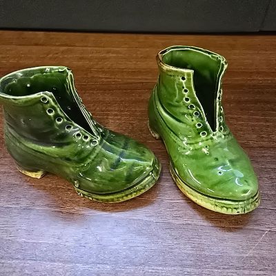A Pair of Victorian Majolica Green Glazed Ceramic Boots. A pair of decorative ceramic novelties 