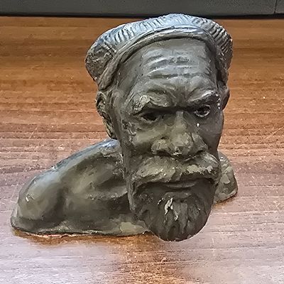 A Highly Textured Plaster Bust of a Bearded Man. A small sculptural bust depicting the head and 