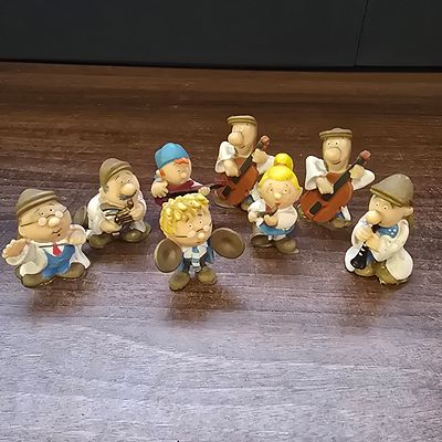 Collection of Nine Tetley Tea Folk Band Figurines and Promotional Coin. A collection of nine 