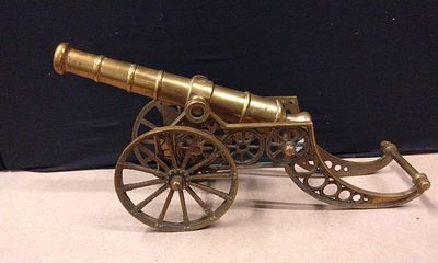 Large Solid Brass Decorative Cannon Model Ornate Carriage. A single brass-colored miniature 