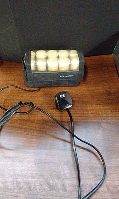 Remington Heated Hair Roller Set with Ten Cream Rollers. A collection of 10 cream-colored heated 
