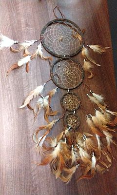 Four-Tier Brown Dream Catcher with Mixed Feathers. A multi-tiered dream catcher consisting of 