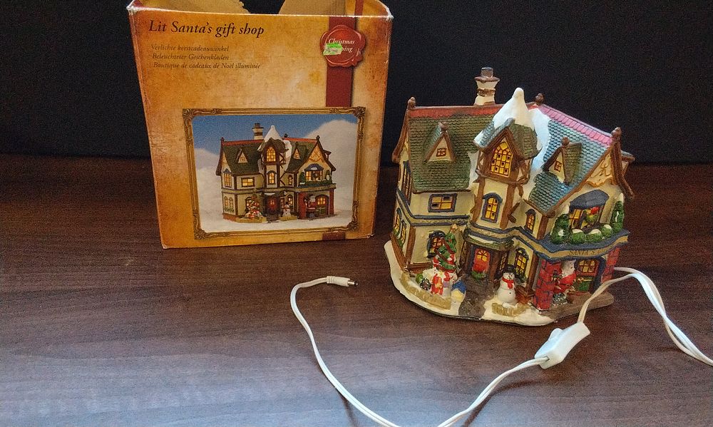 Lot 554: Lit Santa's Gift Shop Ceramic Christmas Village Building. Untested No Power Supply