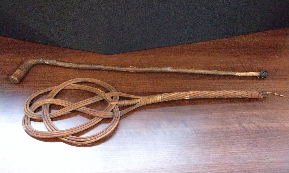 Lot 580: A Wicker Carpet Beater and Wooden Cane