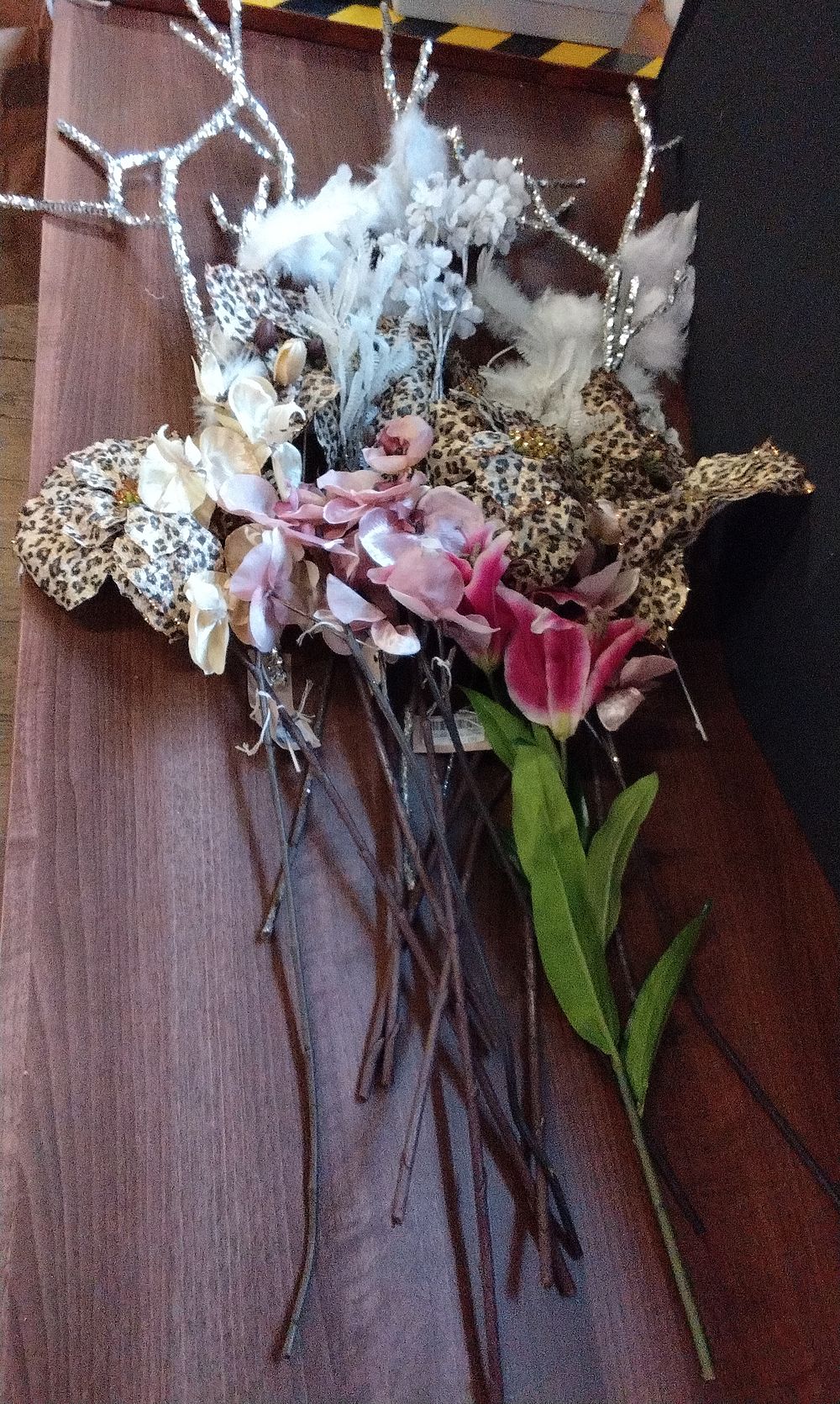 Lot 599: Mixed Bundle of Faux Flowers Feathers and Leopard Print Decor. COLLECTION ONLY