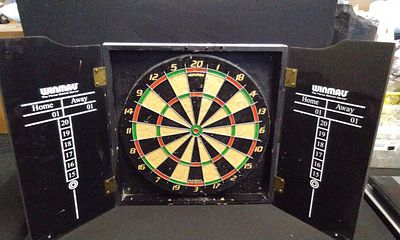 Winmau Black Dartboard Cabinet Set with REBEL Board. A black Winmau dartboard cabinet marked 
