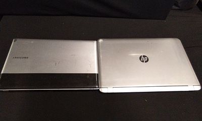 A Pair of Samsung S3520 and HP Core i7 Laptops. A pair of silver and black notebook computers 