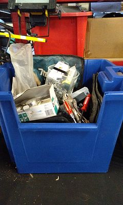 A Collection of Tools and Hardware in a Blue Plastic Tote. A blue plastic tote containing a 