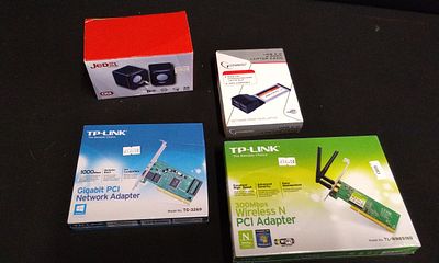 A Collection of Four Boxed Computer Network Adapters and Speakers. A collection of four boxed 