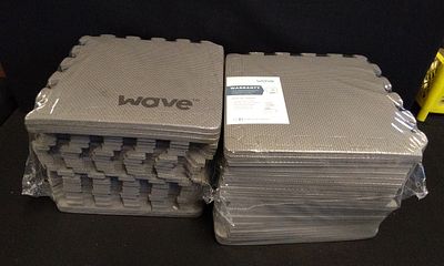 Two Stacks of Wave Interlocking Gray Foam Mats. Two stacks of gray interlocking foam mats 