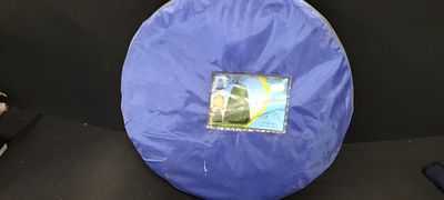 Blue Folded Pop Up Privacy Shower Tent in a Storage Bag. A blue folded privacy or shower tent 