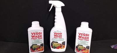 Three Veggi Wash Fruit and Vegetable Wash Bottles. Three Veggi Wash plastic bottles are present 
