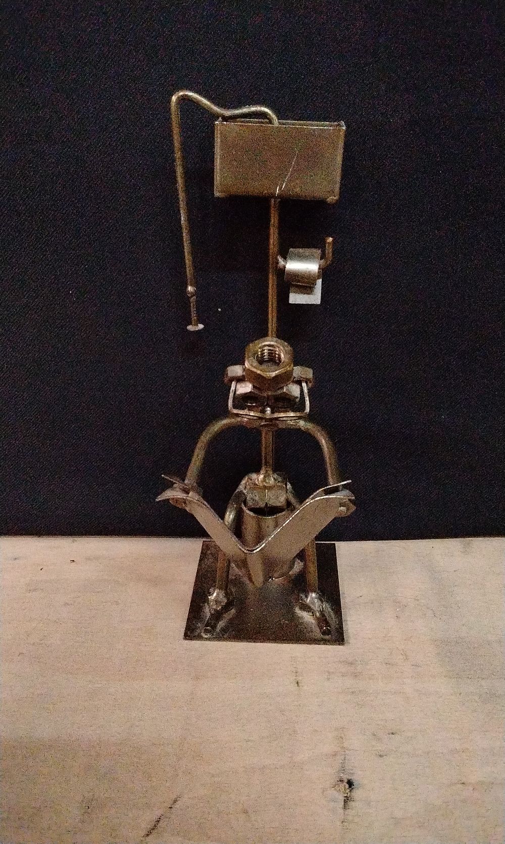Lot 294: Handmade Nuts and Bolts Sculpture of a Person using a Toilet.