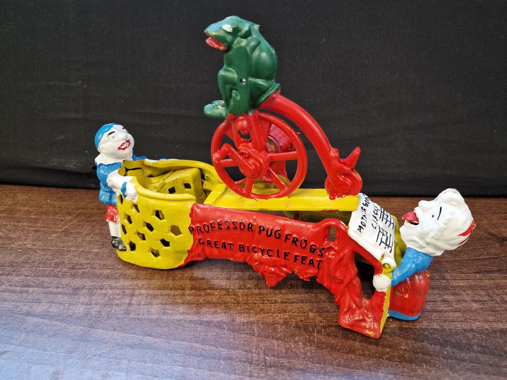 Lot 436: Mother Goose Circus Professor Pug Frogs Great Bicycle Fest Cast Iron Money Box