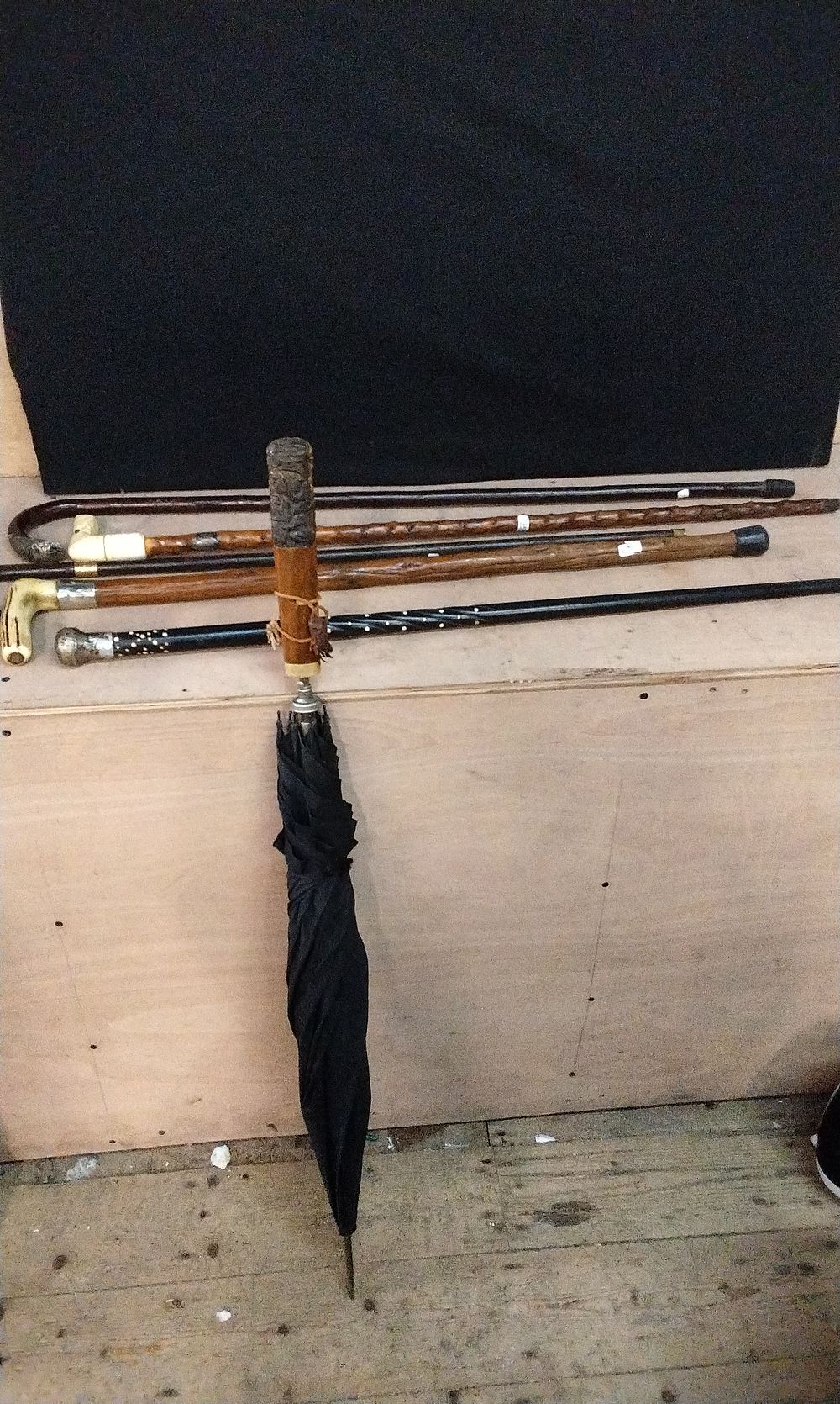 Lot 218: Selection of Various Walking Canes including one with a London 1910 Sterling Silver Collar, with Dog Head Handle. an Ebony and Bone with a White Metal Top. A 8ct Gold Plated Hook Cane, and a Dark Wood Hook Cane with a White metal Mount, and  Vintage Umbre