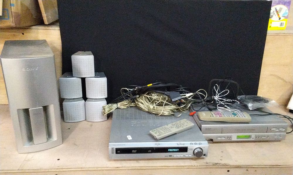 Lot 233: Sharp VHS Player /Recorder VC-MH7705. Tested for Power , S-Master 5.1 Full Digital Amplifier. Tested for Power and 5x Sony Surround Sound Wall Speakers and a Subwoofer. COLLECTION ONLY
