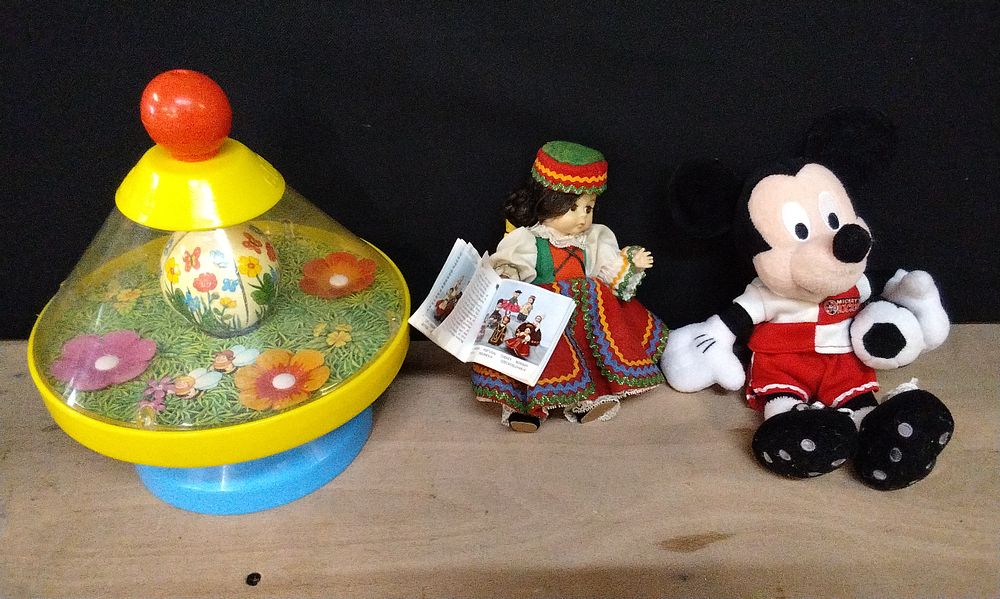 Lot 346: Vintage Chicco Spinning Top with a Bumblebee, Madame Alexander Little Women Chech Doll, and a Walt Disney World Mickey Mouse Plush Toy