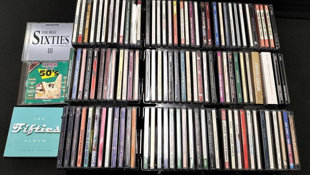 Lot 210: A Collection of over 100 Music CDs in plastic storage units.