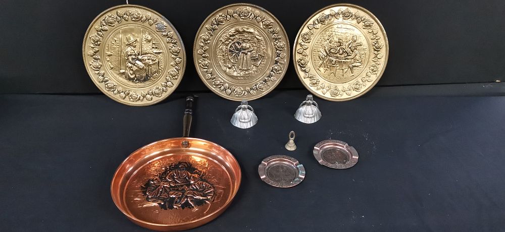Lot 177: Selection of Mixed Brass Wall Plates, Decorative Copper Pan, Two Toronto Ashtrays, Two Metal Crinolin Ladies, and a Brass Miniature Bell