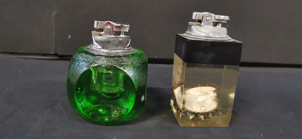 Lot 179: Two Vintage Table Lighters, One Resin with an Oyster with Pearl and One Vintage Emerald Green Glass Desk Lighter,