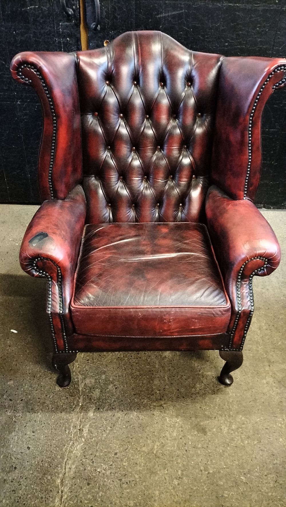 Lot 228: A Ox Blood Leather Chesterfield Queen Anne Wingback Armchair