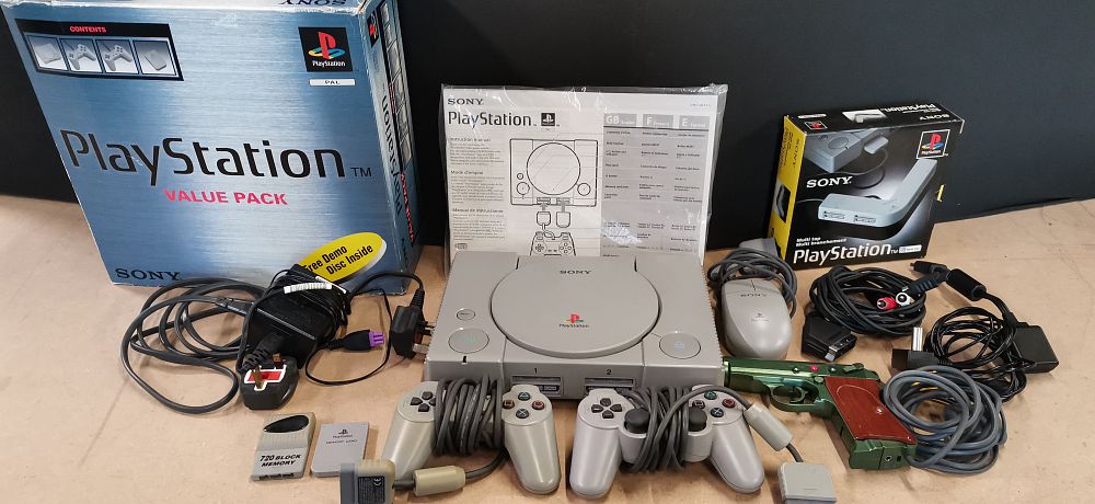 Lot 228: A Boxed Sony PlayStation One SCPH-5552 Console and Accessories. Tested for Power